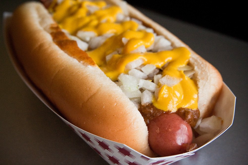 hot dog topped with mustard, meat sauce, and raw onion better known as a detroit coney dog