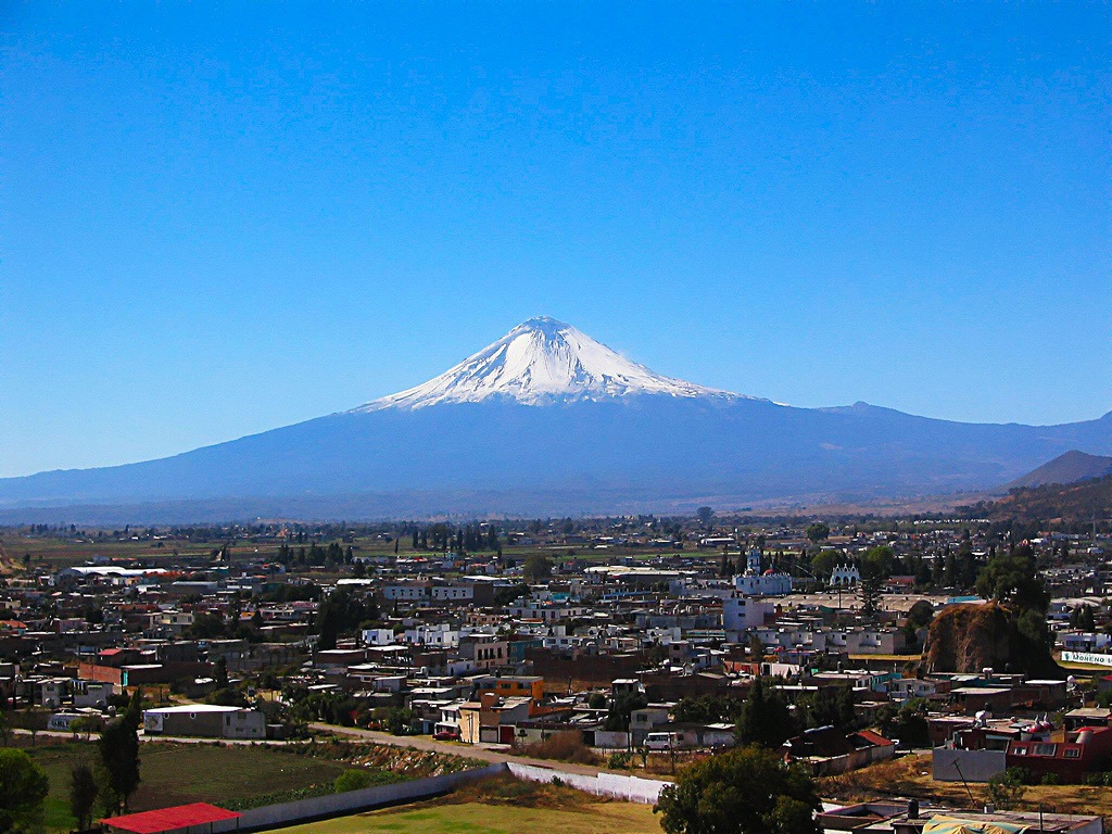 A view of Cholula and the Popo volcano in the background