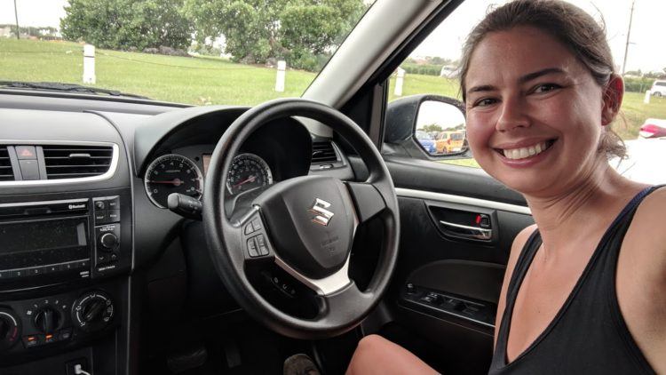 becky inside barbados rental car, with driver side on the opposite side from usa