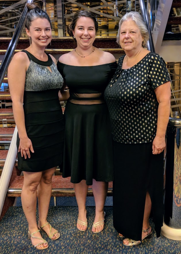 three women in cocktail dresses