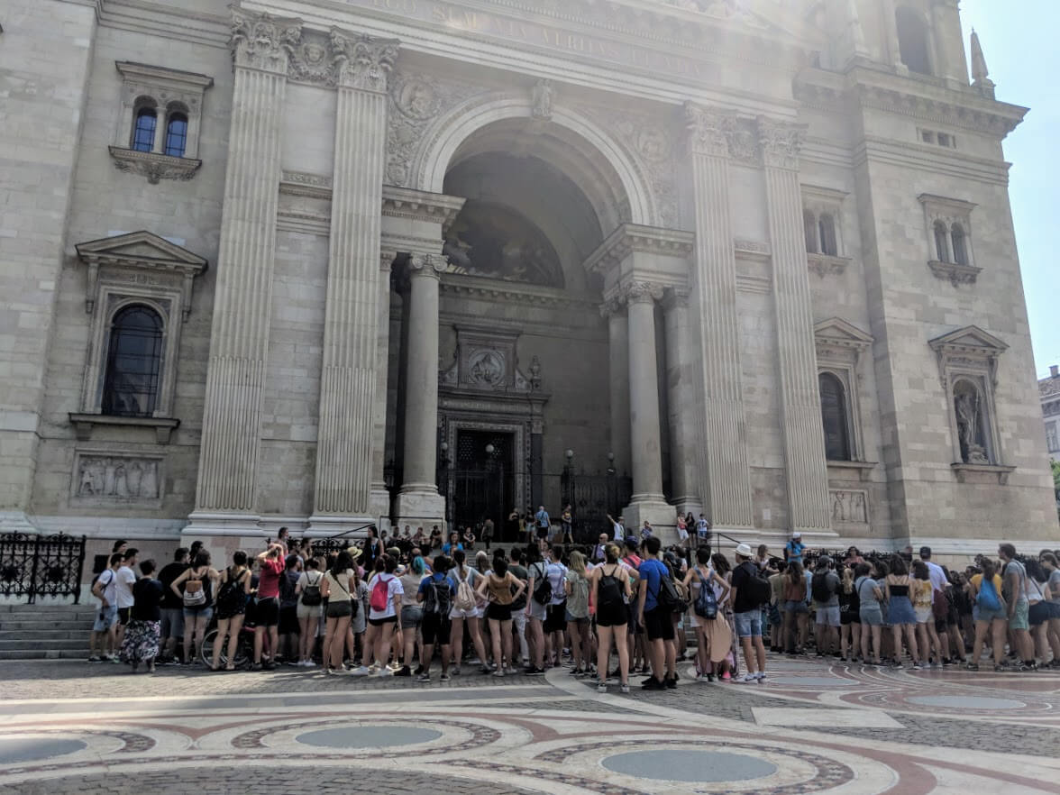 60 people standing in front of budapest church
