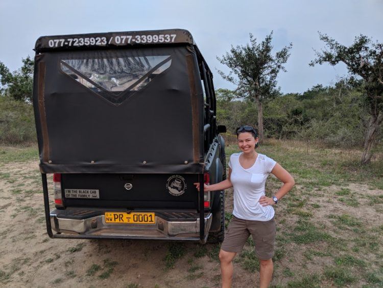 modeling a safari outfit next to jeep