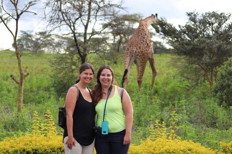 safari clothes for women in front of a giraffe