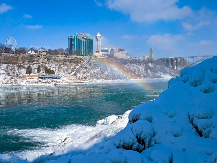 rainbow at the base of the waterfalls