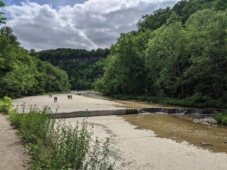 people walking along taughhanock creek near ithaca