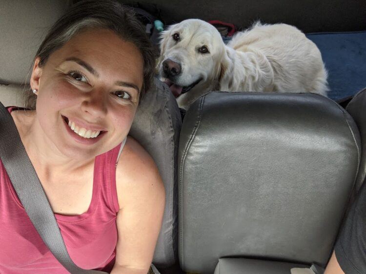 dog and woman sitting in car
