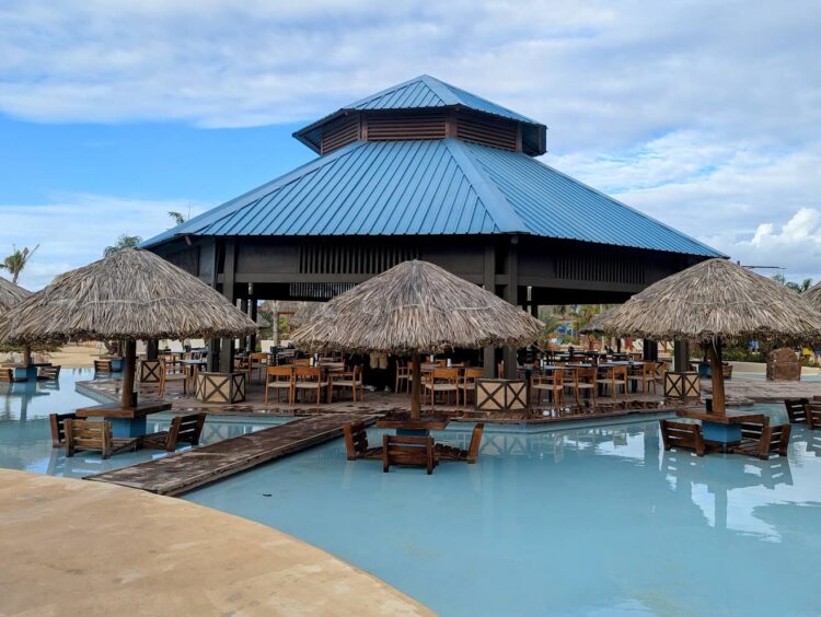 restaurant with tables and chairs directly in the pool