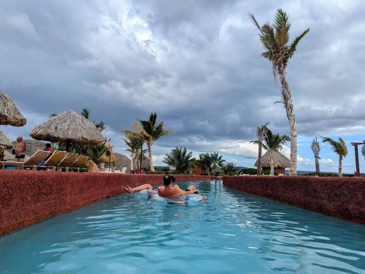 two people floating in inner tubes on lazy river